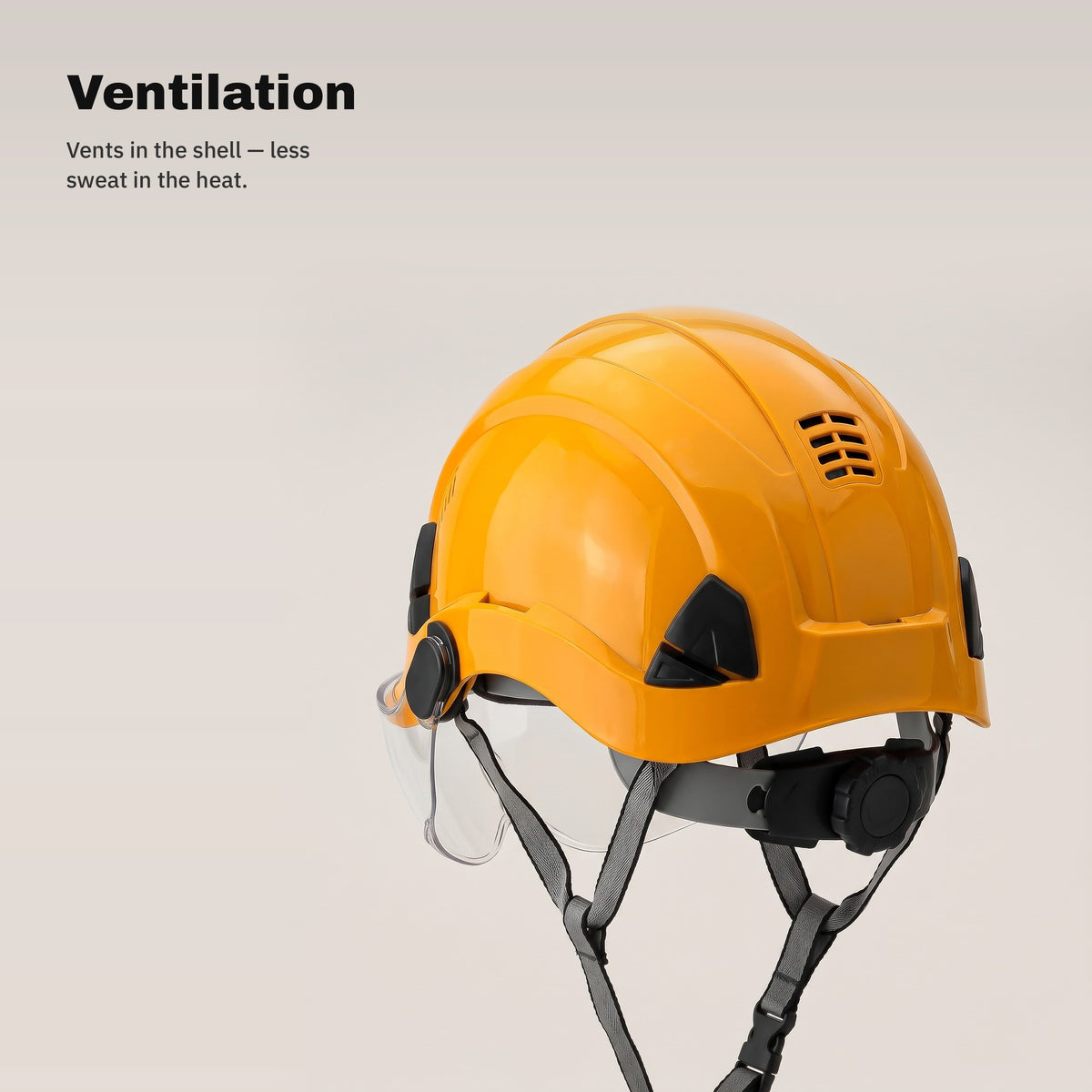 Ventilation slots in the shell of the orange safety helmet